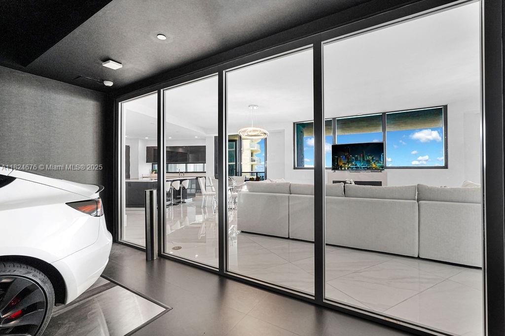 18555 Collins Avenue, Unit 2605 Sunny Isles Beach, FL 33160 - Photo 11 of 22 a kitchen with white cabinets and a fireplace