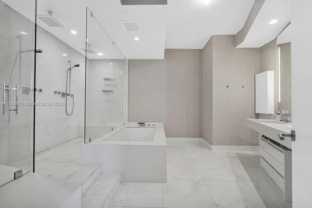 a spacious bathroom with a tub shower and sink