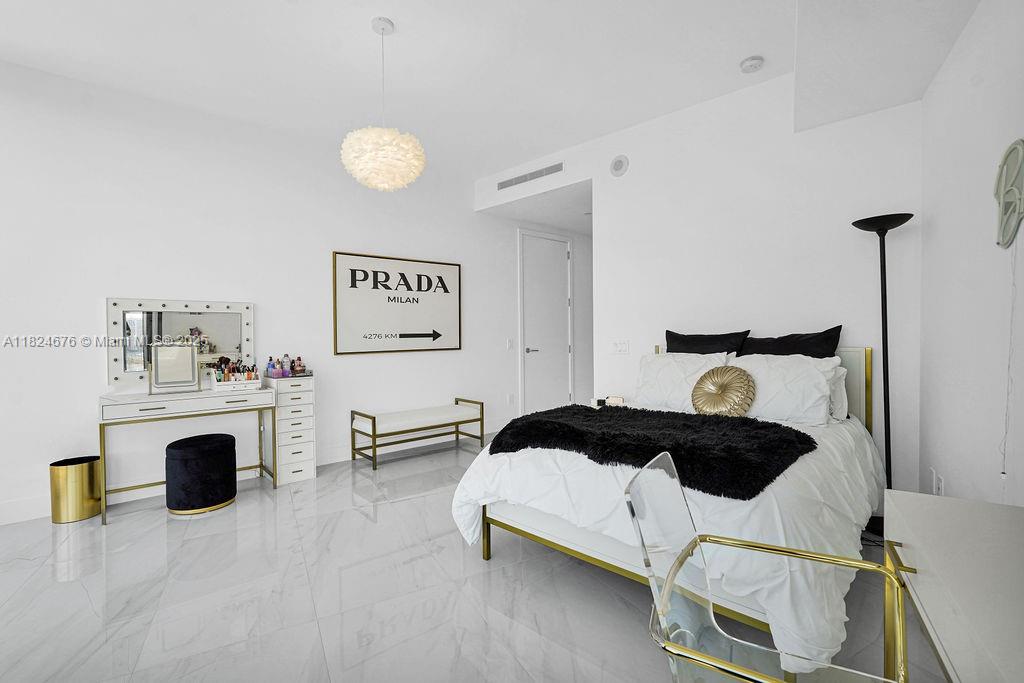 18555 Collins Avenue, Unit 2605 Sunny Isles Beach, FL 33160 - Photo 17 of 22 a kitchen with a refrigerator and a stove