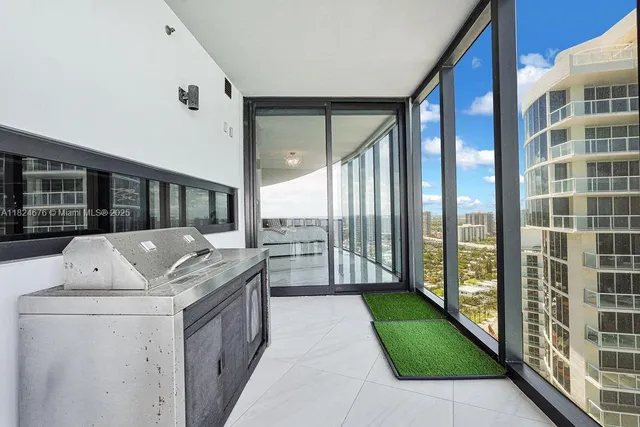 a living room with a bed and a large window