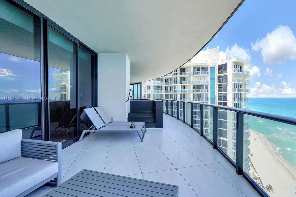 18555 Collins Avenue, Unit 2605 Sunny Isles Beach, FL 33160 - Photo 22 of 22 a building outdoor space with patio furniture