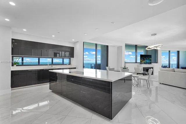 a large kitchen with a large counter top furniture and appliances