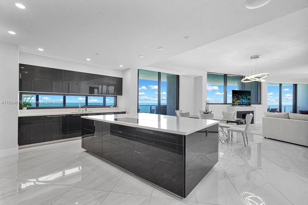 18555 Collins Avenue, Unit 2605 Sunny Isles Beach, FL 33160 - Photo 9 of 22 a large kitchen with a large counter top furniture and appliances