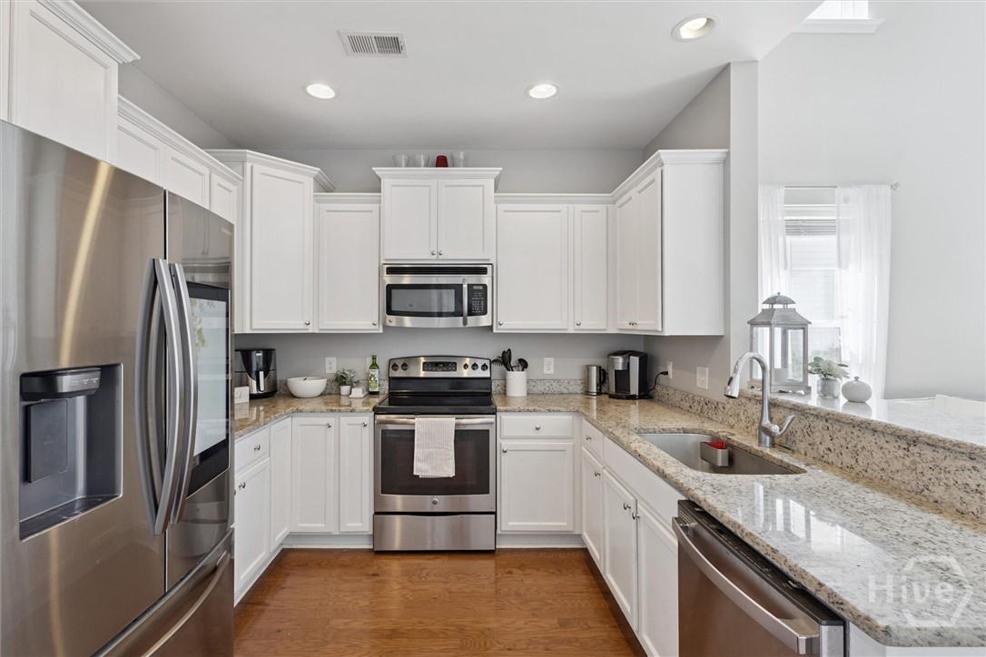 75 Timber Crest Court Savannah, GA 31407 - Photo 11 of 43 The pantry, laundry room, and garage access is located opposite the kitchen.