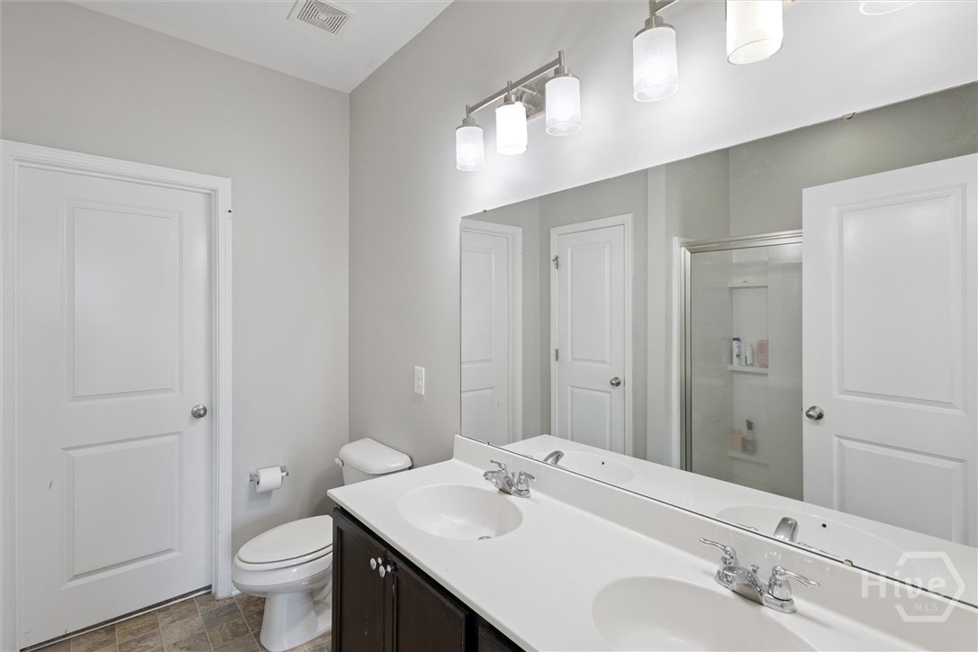 75 Timber Crest Court Savannah, GA 31407 - Photo 21 of 43 The primary bathroom features a double vanity, tons of cabinet space, a walk-in shower with glass doors and a walk-in closet.