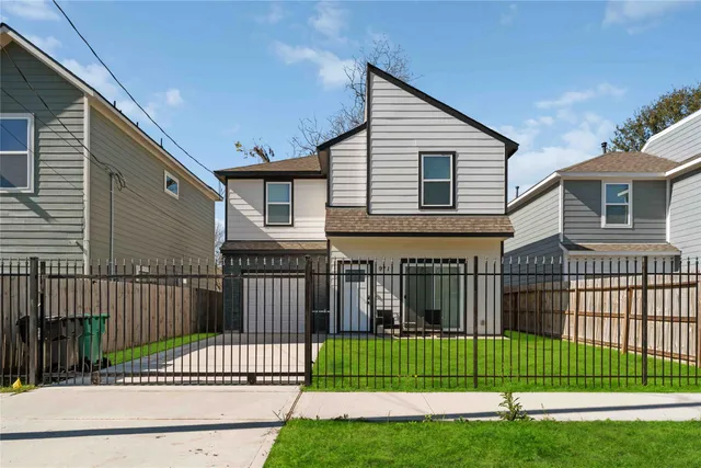 a front view of a house with a garden and deck