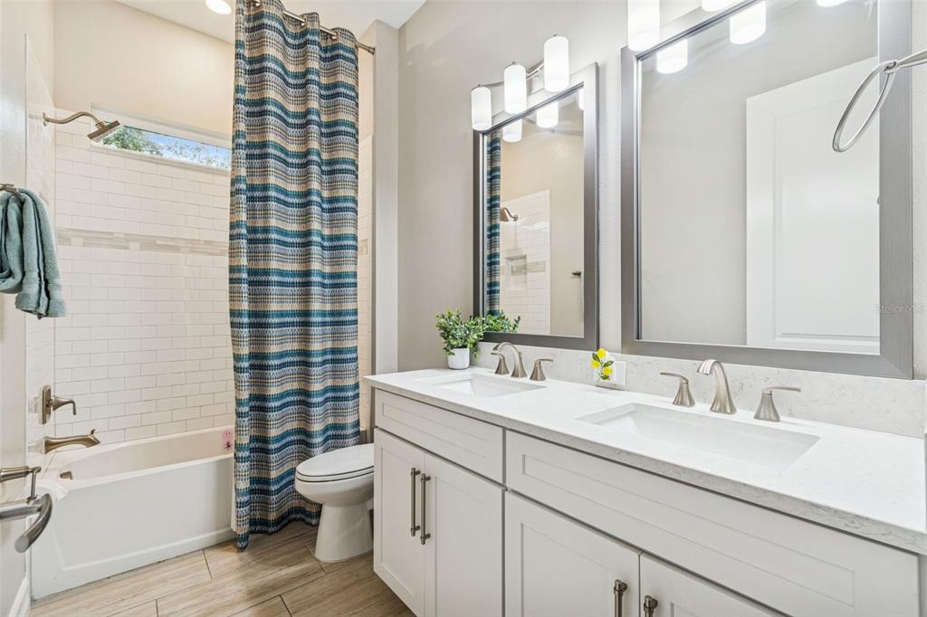 2519 Cordoba Ranch Boulevard Lutz, FL 33559 - Photo 13 of 77 a bathroom with a granite countertop sink toilet and shower