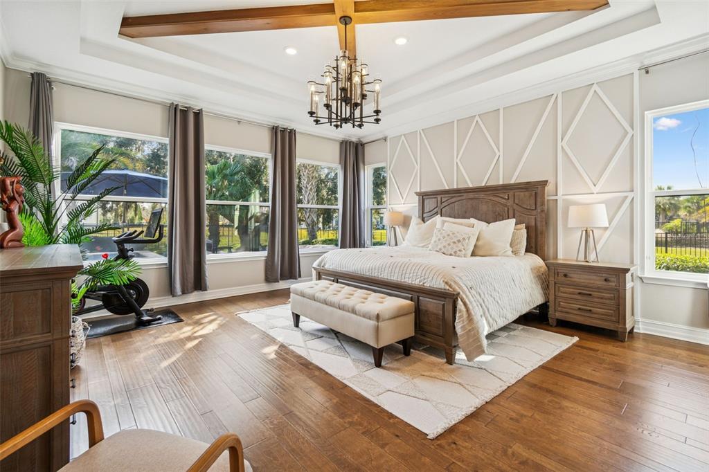 2519 Cordoba Ranch Boulevard Lutz, FL 33559 - Photo 33 of 77 a spacious bedroom with a large bed and a chandelier