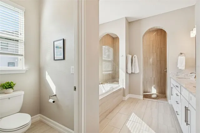 a view of a house with a big yard and palm trees