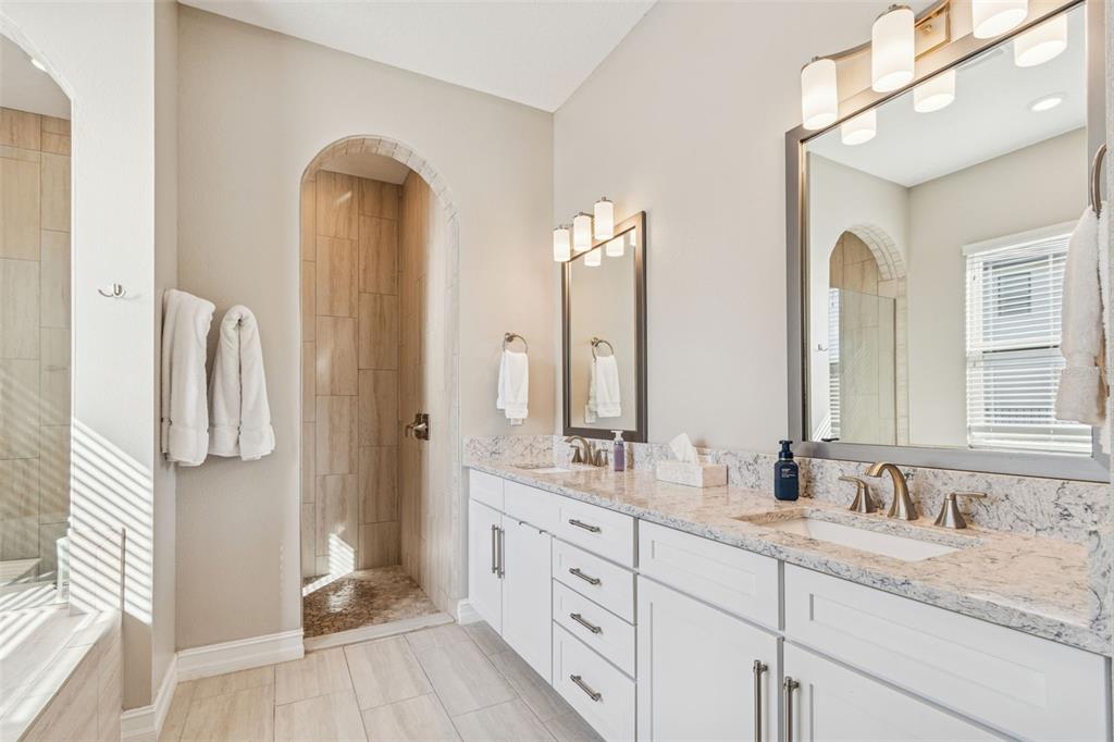 2519 Cordoba Ranch Boulevard Lutz, FL 33559 - Photo 41 of 77 a bathroom with a double vanity sink and a mirror
