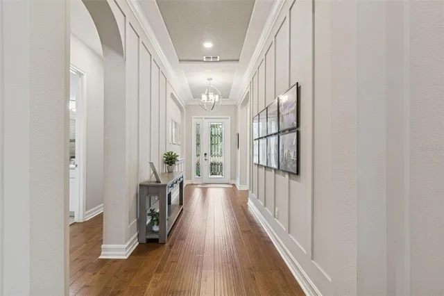 a view of a hallway with wooden floor