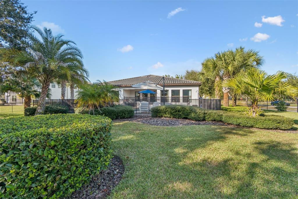 2519 Cordoba Ranch Boulevard Lutz, FL 33559 - Photo 54 of 77 a view of a house with a big yard and palm trees
