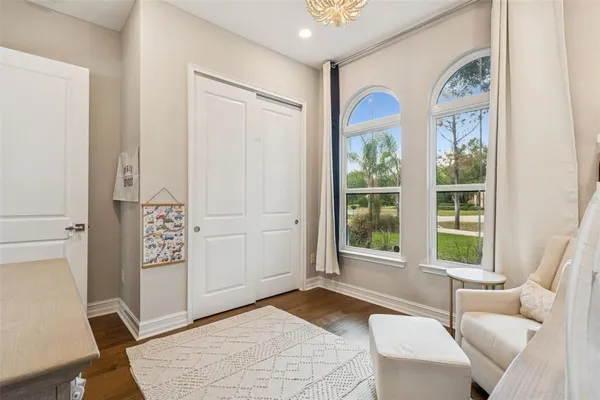 a living room with furniture and wooden floor