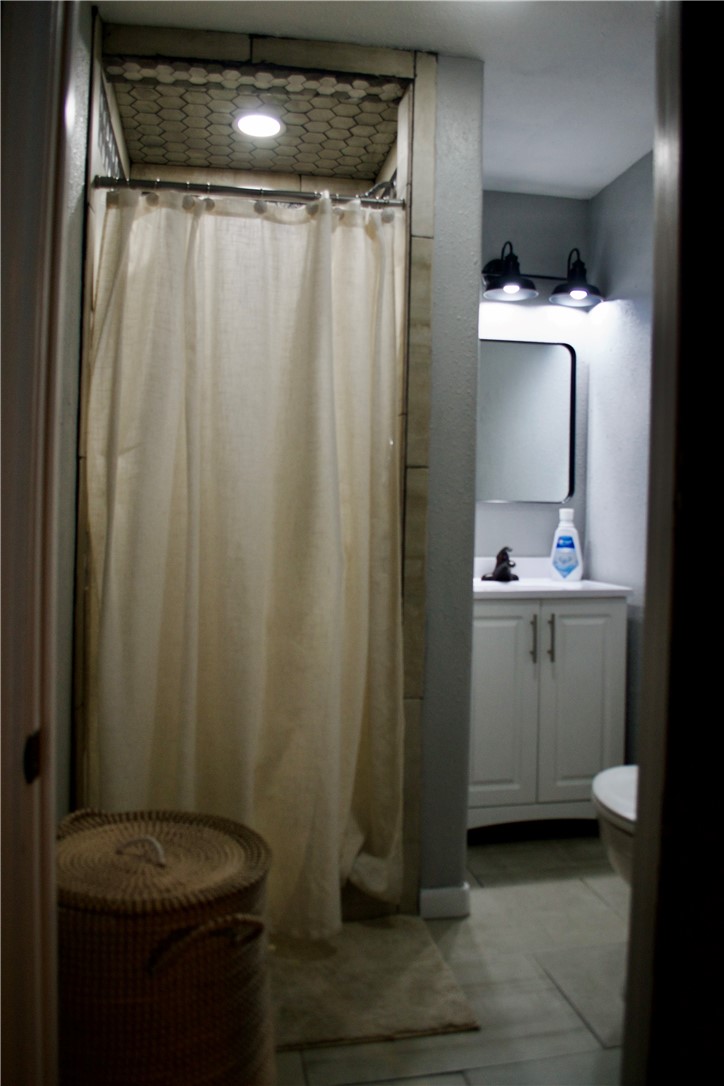 1001 East Hefferman Street Beeville, TX 78102 - Photo 12 of 12 a bathroom with a sink a toilet and shower