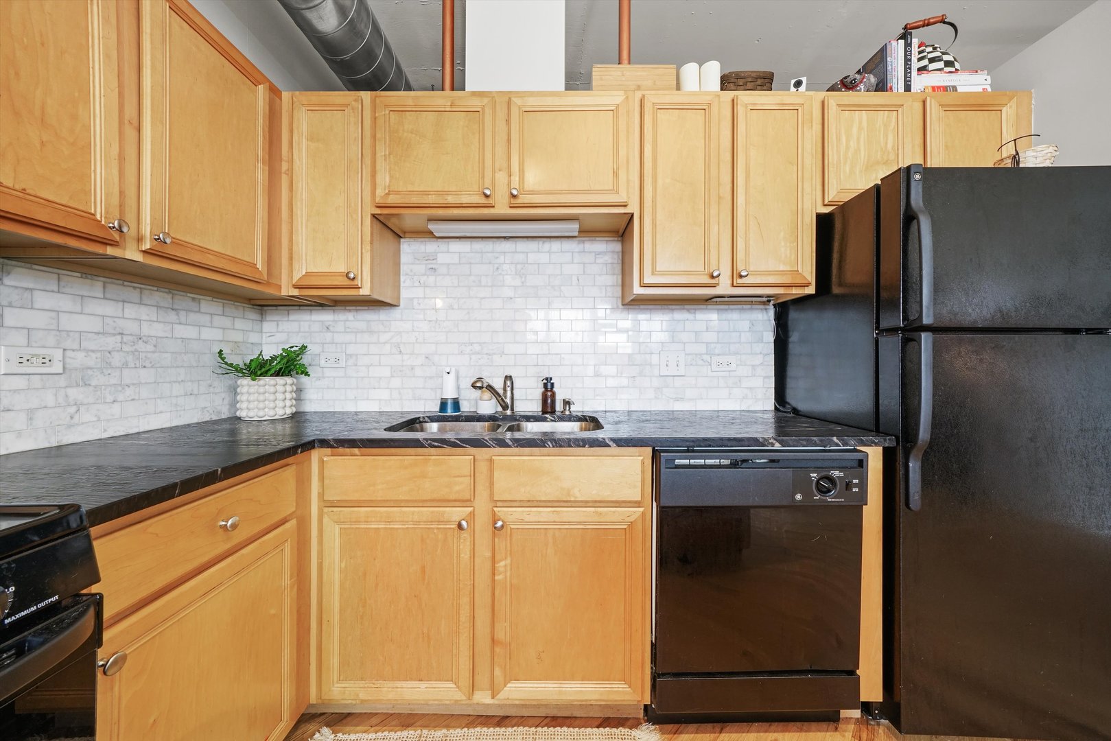 500 South Clinton Street, Unit 424 Chicago, IL 60607 - Photo 12 of 29 a kitchen with stainless steel appliances granite countertop a refrigerator a stove a sink and white cabinets
