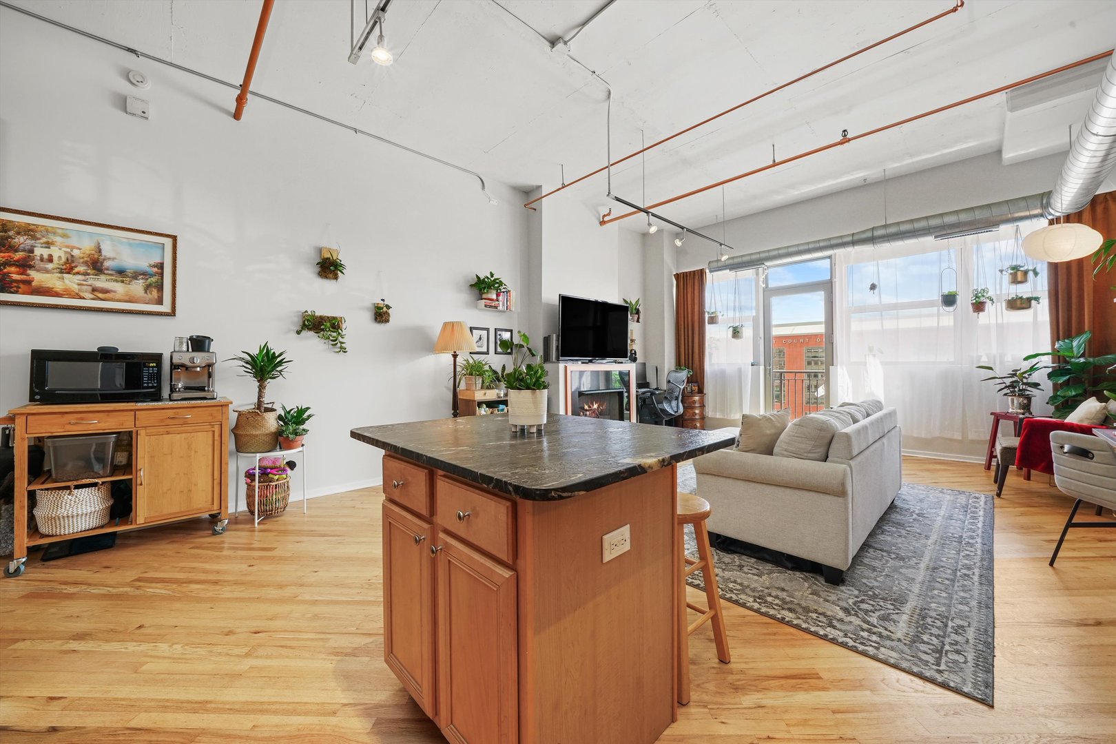 500 South Clinton Street, Unit 424 Chicago, IL 60607 - Photo 7 of 29 a living room with furniture flat screen tv and a fireplace
