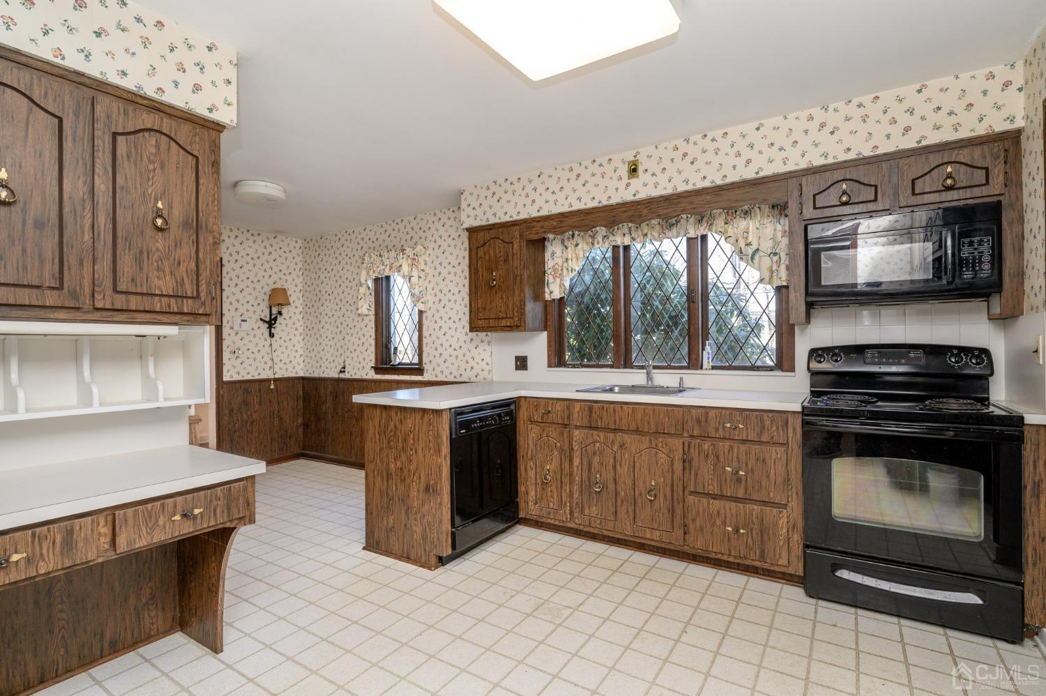 6 Far View Drive Mountainside, NJ 07092 - Photo 11 of 45 a kitchen with stainless steel appliances granite countertop a stove a sink and a microwave