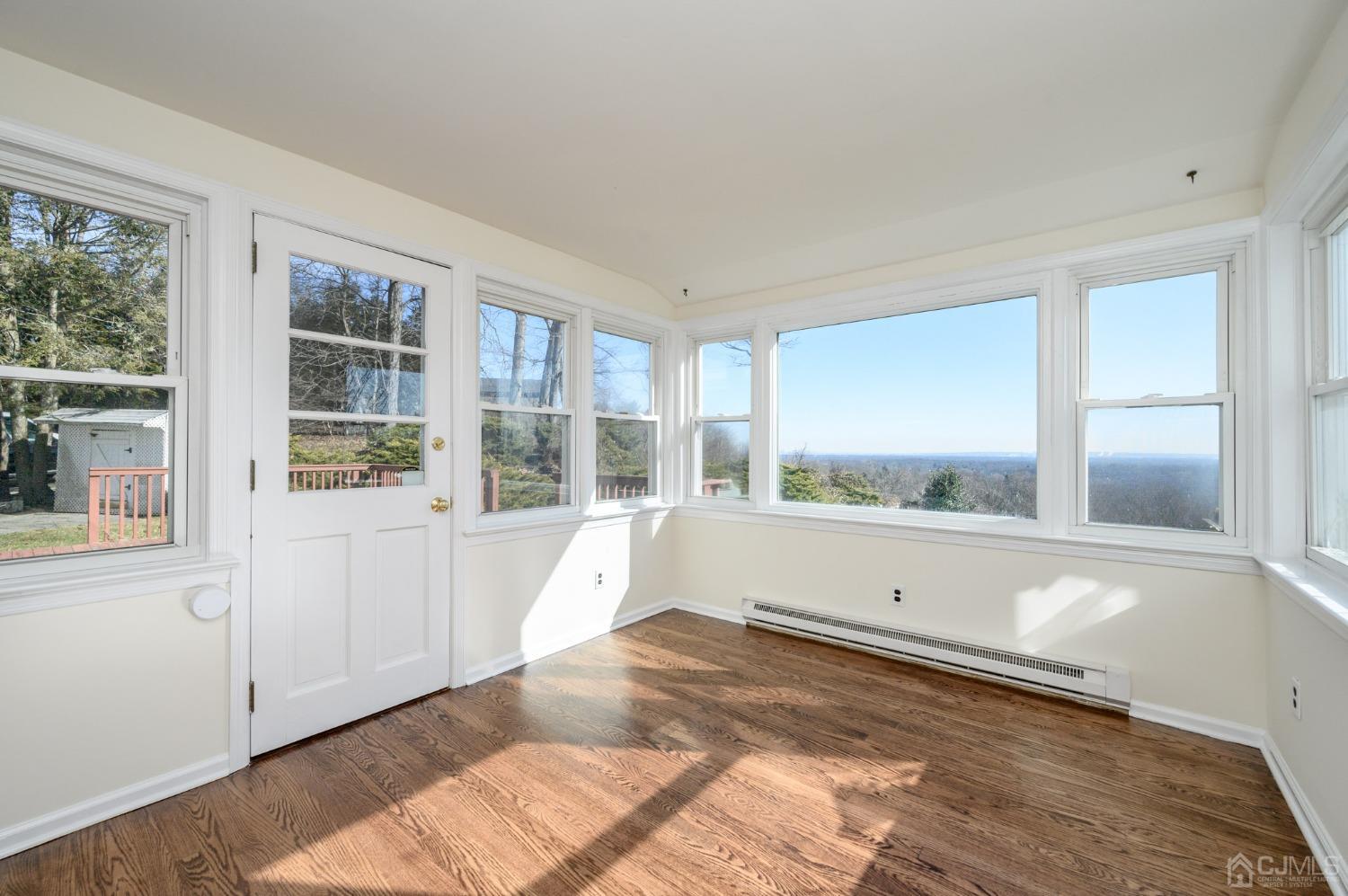 6 Far View Drive Mountainside, NJ 07092 - Photo 17 of 45 a view of an empty room with a window and wooden floor