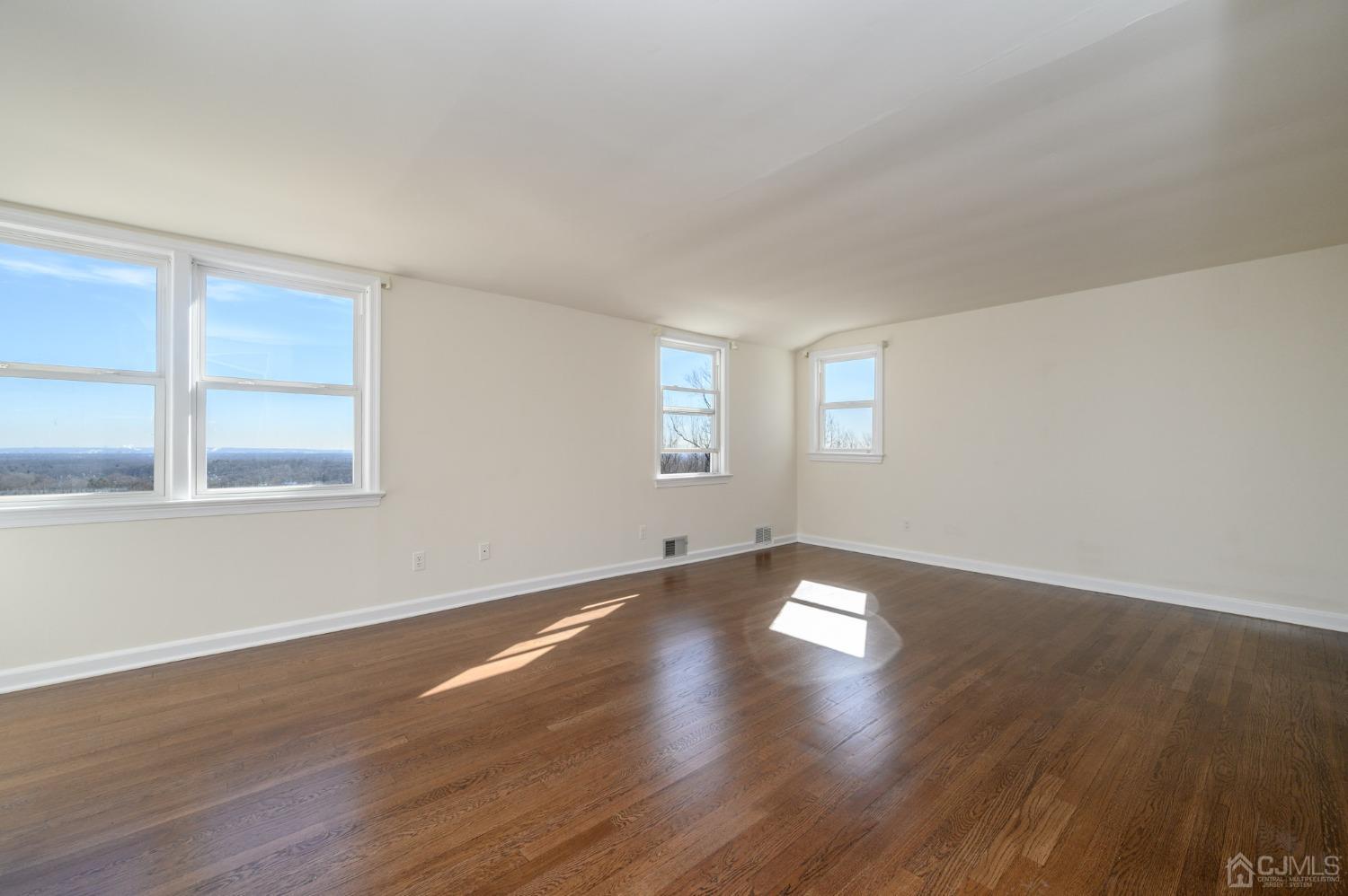 6 Far View Drive Mountainside, NJ 07092 - Photo 22 of 45 a view of an empty room with wooden floor and window