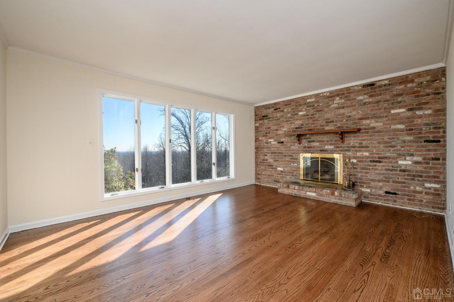 6 Far View Drive Mountainside, NJ 07092 - Photo 4 of 45 a view of an empty room with wooden floor and a window
