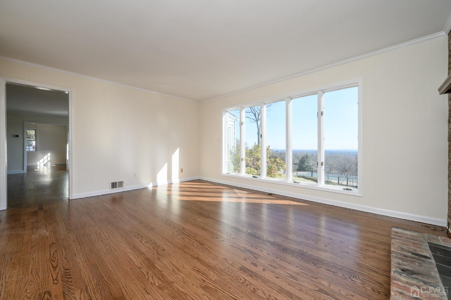 6 Far View Drive Mountainside, NJ 07092 - Photo 5 of 45 a view of empty room with wooden floor and fan