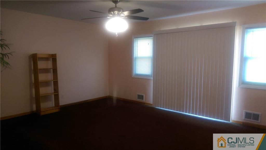 4 Yale Road Old Bridge, NJ 08859 - Photo 4 of 17 wooden floor in an empty room with a window