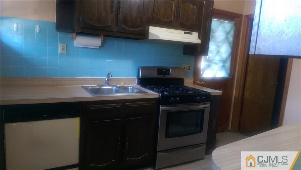 4 Yale Road Old Bridge, NJ 08859 - Photo 7 of 17 a kitchen with a sink and a stove