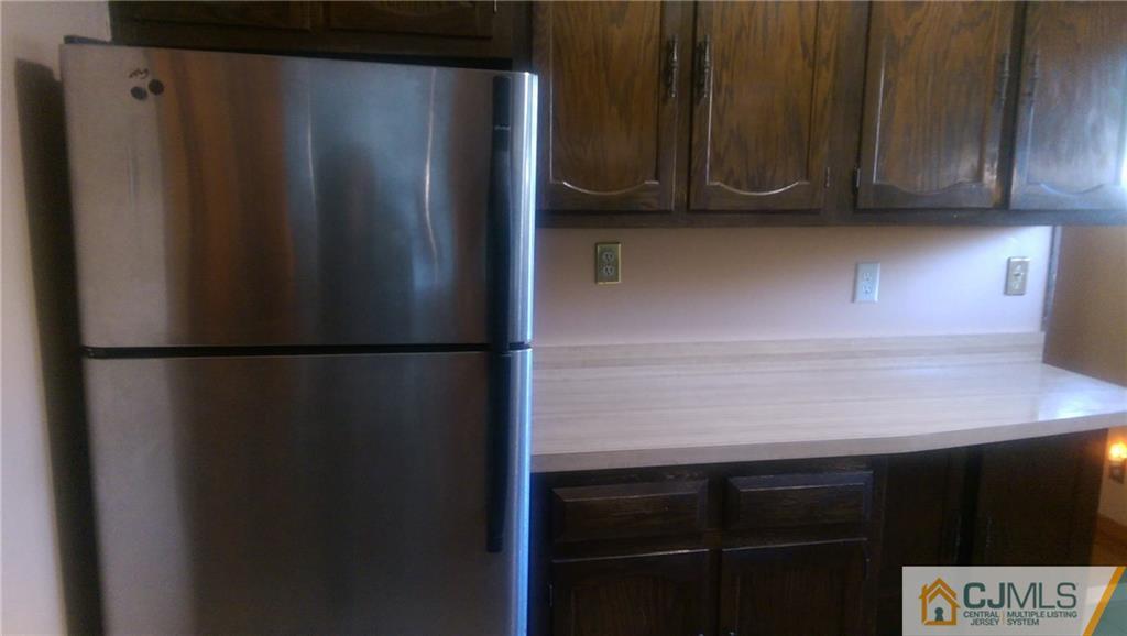 4 Yale Road Old Bridge, NJ 08859 - Photo 8 of 17 a close view of a refrigerator in kitchen with stainless steel appliances wooden cabinet