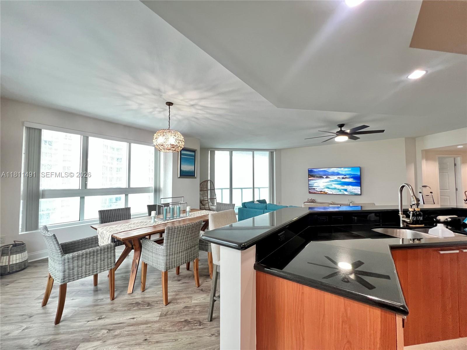 231 Riverside Drive, Unit 1210 Daytona Beach, FL 32117 - Photo 12 of 70 a kitchen that has a table and chairs in it