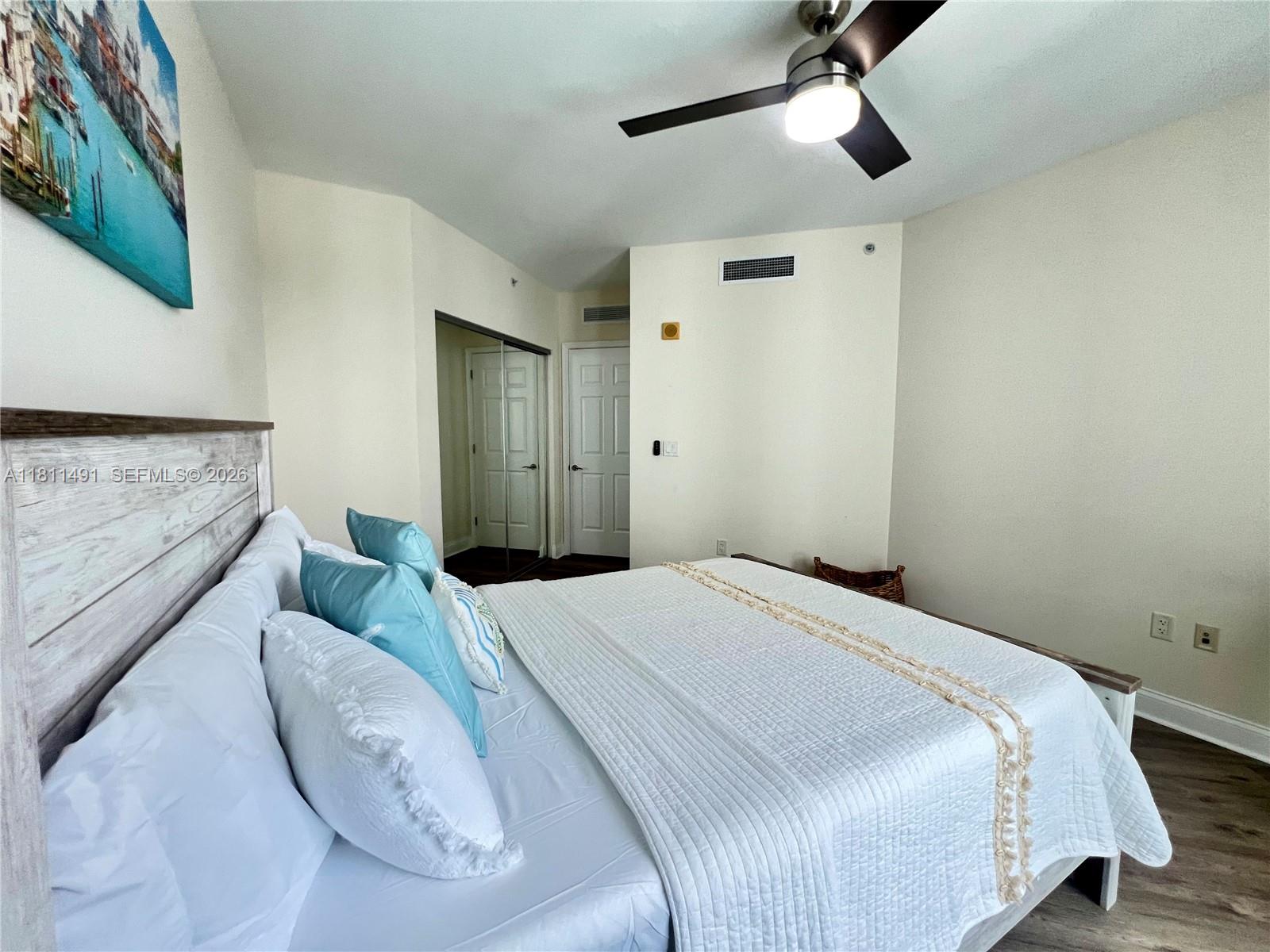 231 Riverside Drive, Unit 1210 Daytona Beach, FL 32117 - Photo 31 of 70 a bedroom with a bed and ceiling fan