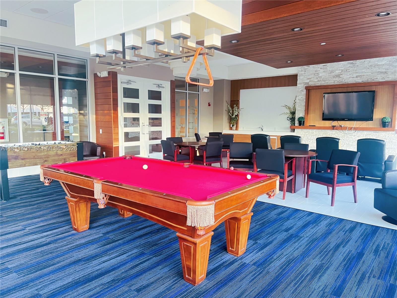 231 Riverside Drive, Unit 1210 Daytona Beach, FL 32117 - Photo 47 of 70 a room with wooden floors table and windows