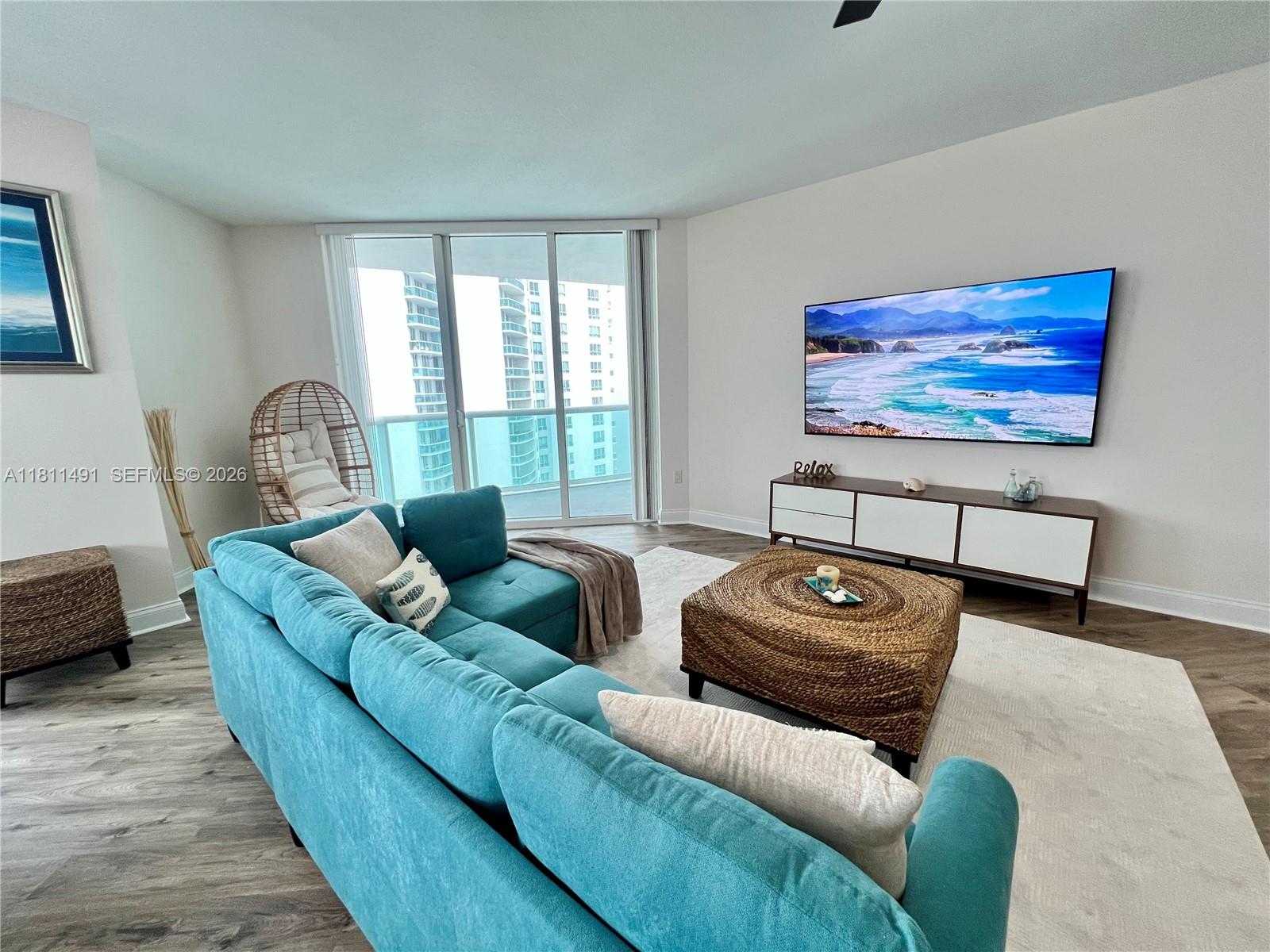 231 Riverside Drive, Unit 1210 Daytona Beach, FL 32117 - Photo 8 of 70 a living room with furniture and a flat screen tv