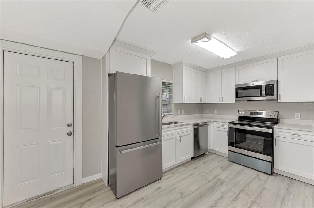 1891 Prospect Street Sarasota, FL 34239 - Photo 12 of 35 a kitchen with stainless steel appliances a refrigerator sink and microwave