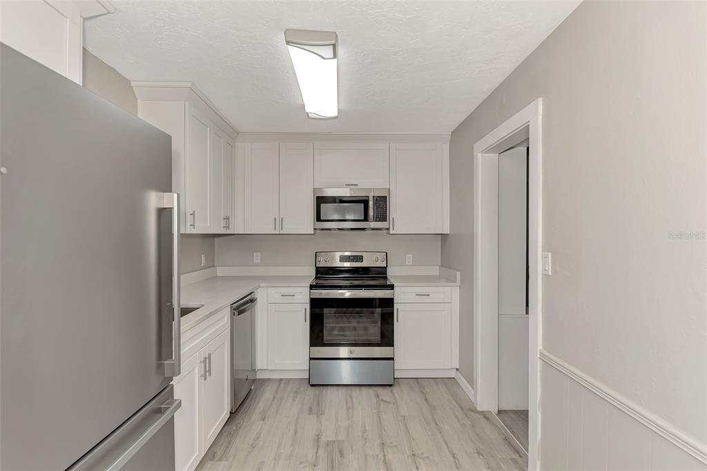 1891 Prospect Street Sarasota, FL 34239 - Photo 13 of 35 a kitchen with stainless steel appliances granite countertop white cabinets and a stove