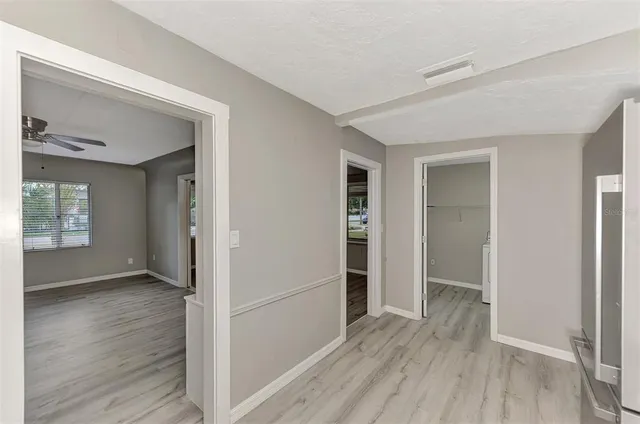 a view of empty room with wooden floor
