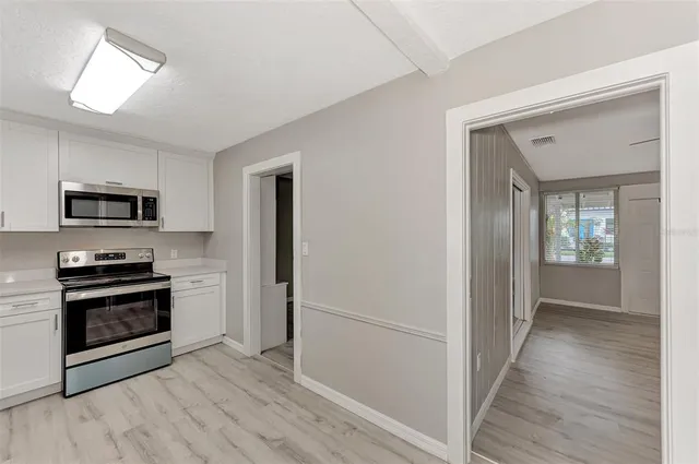 a view of a kitchen from a hallway