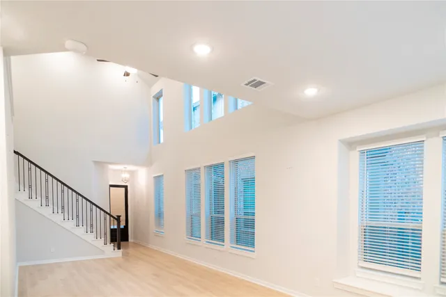a view of staircase with wooden floor and windows