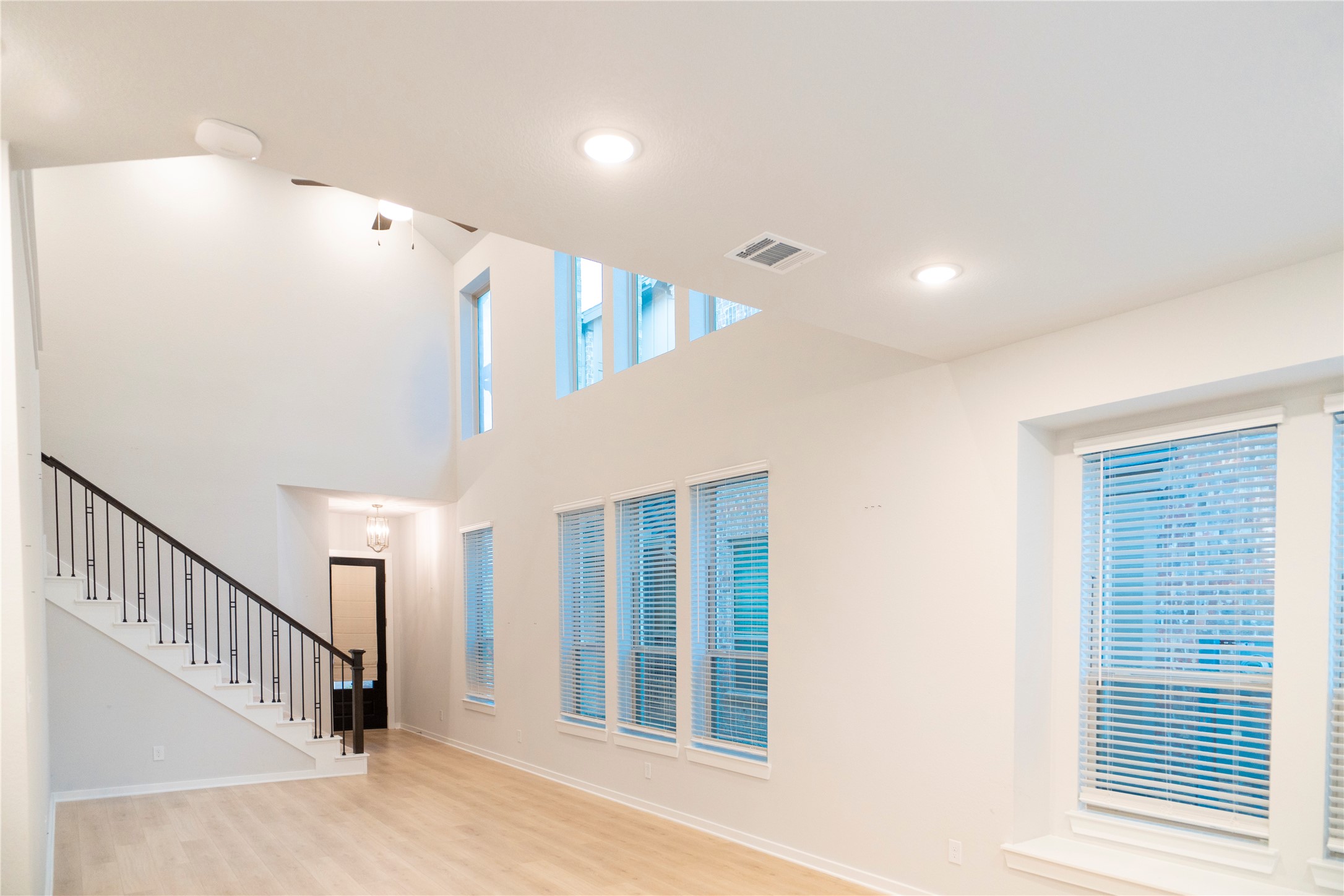 6519 Bramble Cv Lane Fulshear, TX 77441 - Photo 4 of 29 a view of staircase with wooden floor and windows