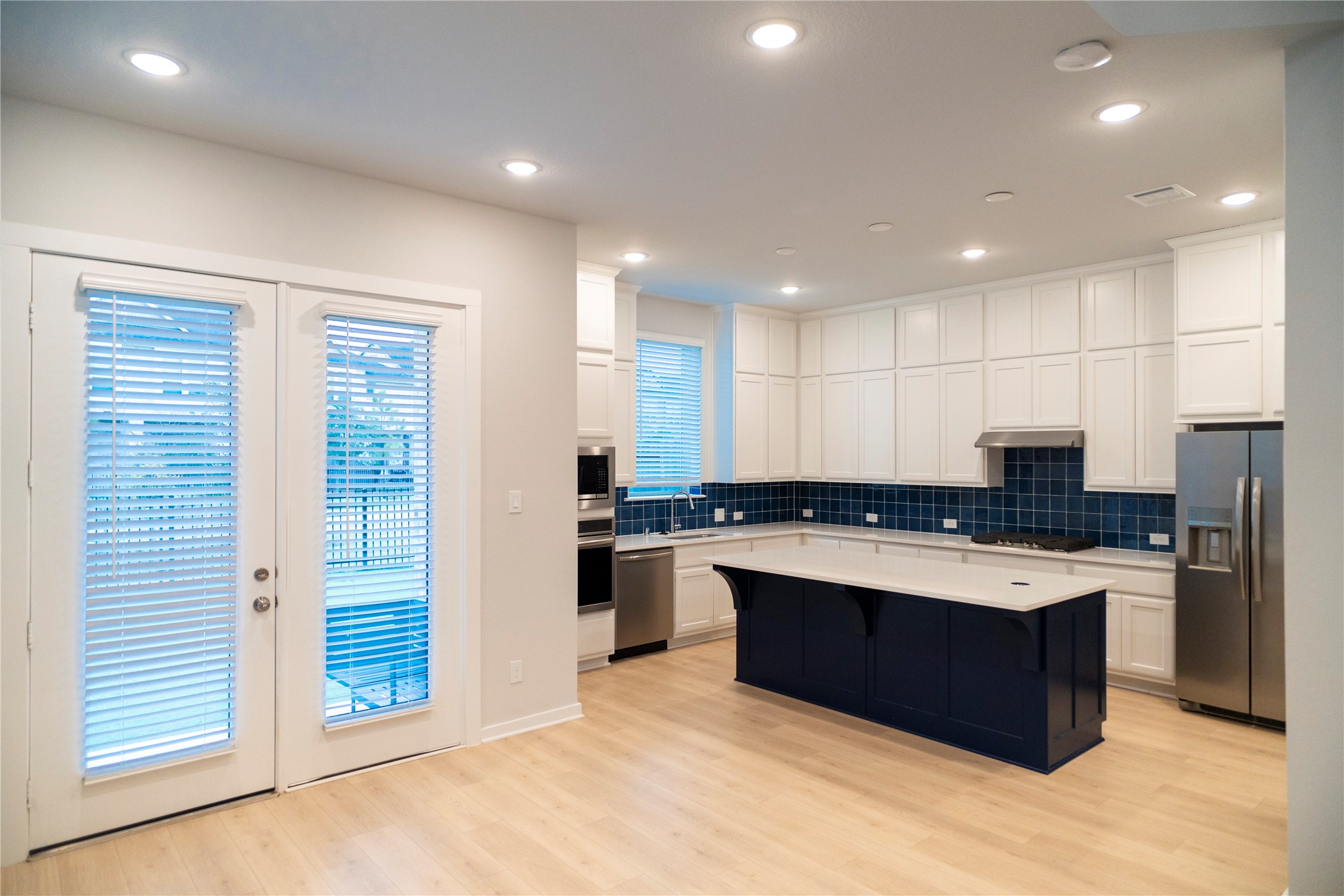6519 Bramble Cv Lane Fulshear, TX 77441 - Photo 7 of 29 a large kitchen with stainless steel appliances granite countertop a stove a sink dishwasher a refrigerator and a oven