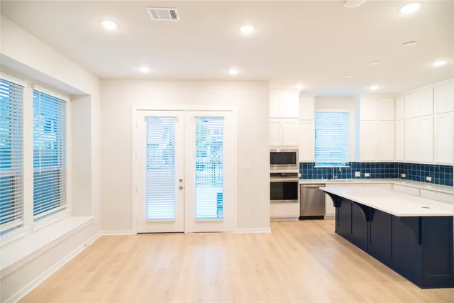 a kitchen with a sink and white cabinets