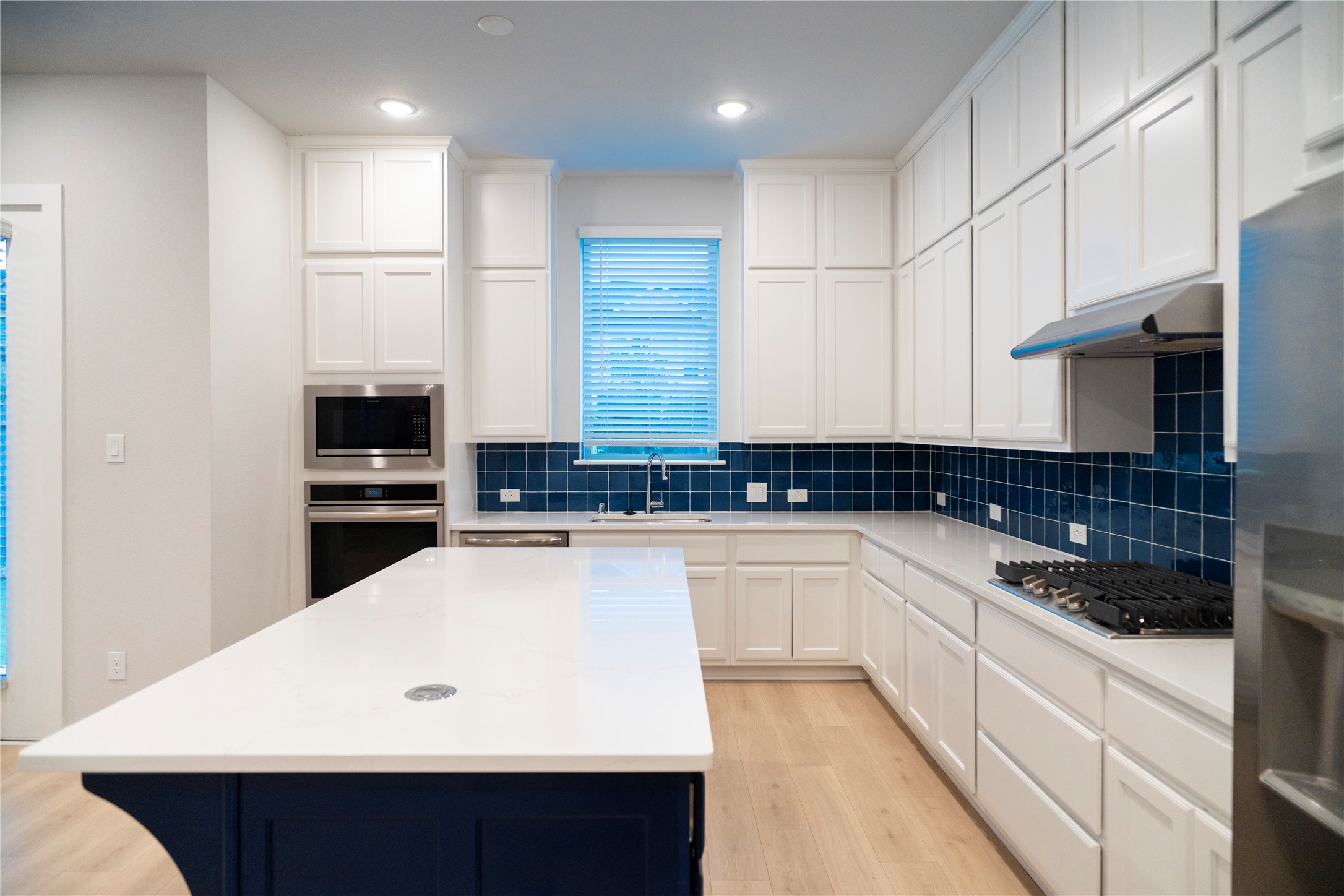 6519 Bramble Cv Lane Fulshear, TX 77441 - Photo 9 of 29 a kitchen with a sink and white cabinets