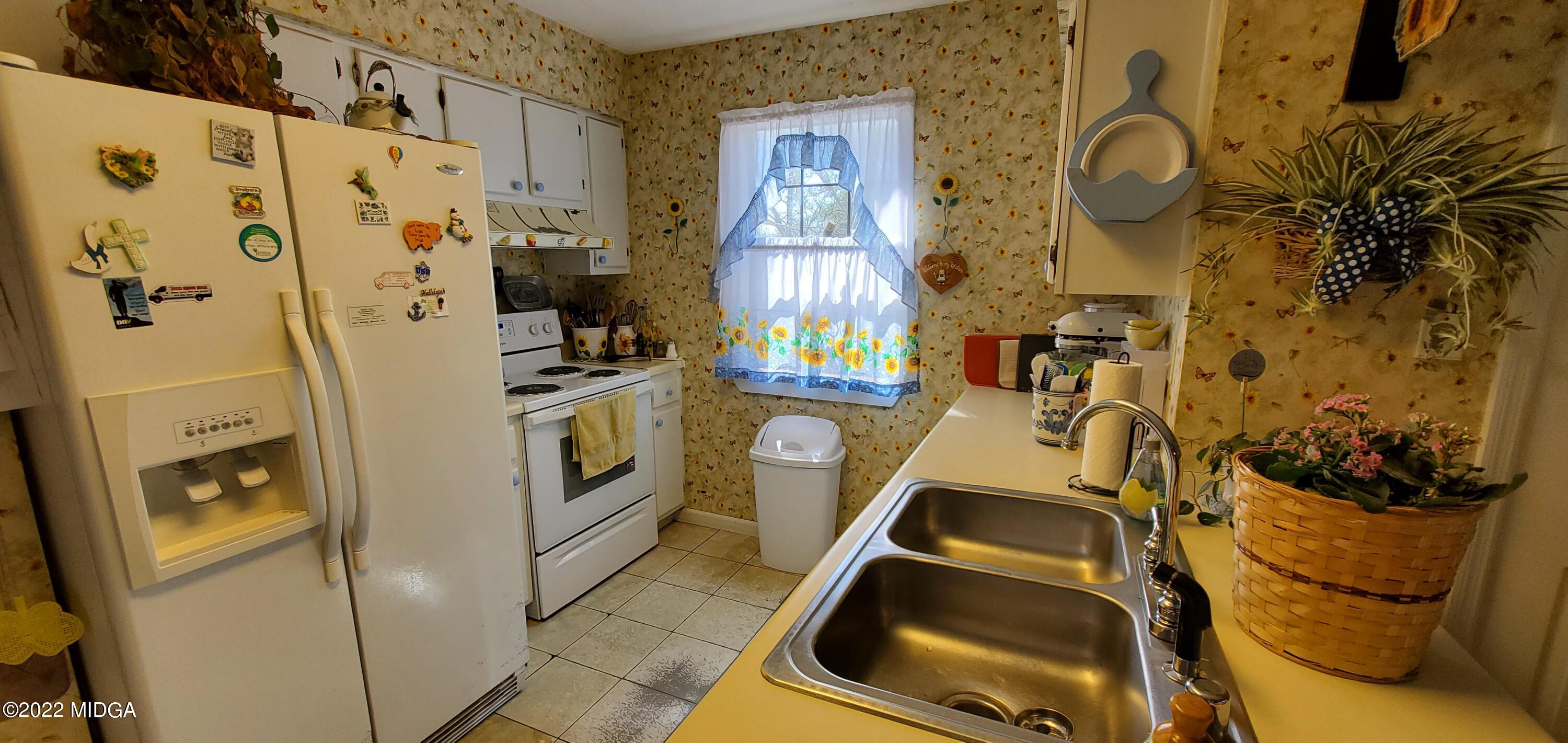 5757 Rogers Road Lizella, GA 31052 - Photo 5 of 23 a view of a kitchen with a sink and refrigerator