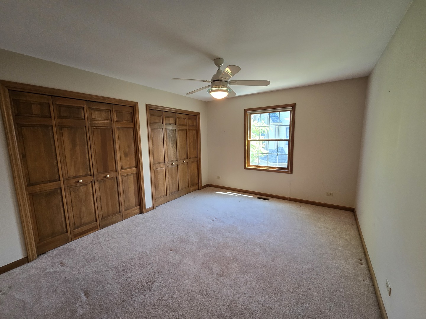 2286 Brookside Lane Aurora, IL 60502 - Photo 16 of 32 an empty room with windows and ceiling fan