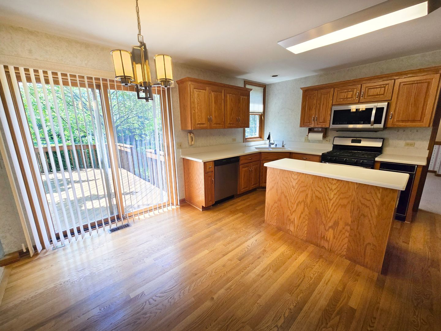 2286 Brookside Lane Aurora, IL 60502 - Photo 5 of 32 a view of a kitchen with a sink wooden floor and a window