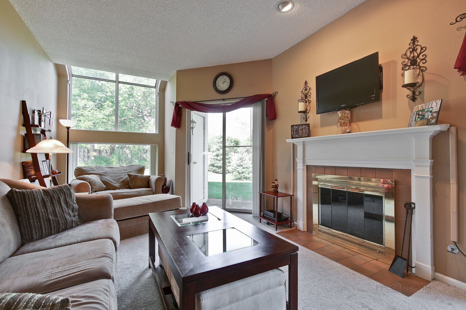 1271 Ranchview Court Buffalo Grove, IL 60089 - Photo 11 of 25 a living room with furniture a fireplace and a flat screen tv
