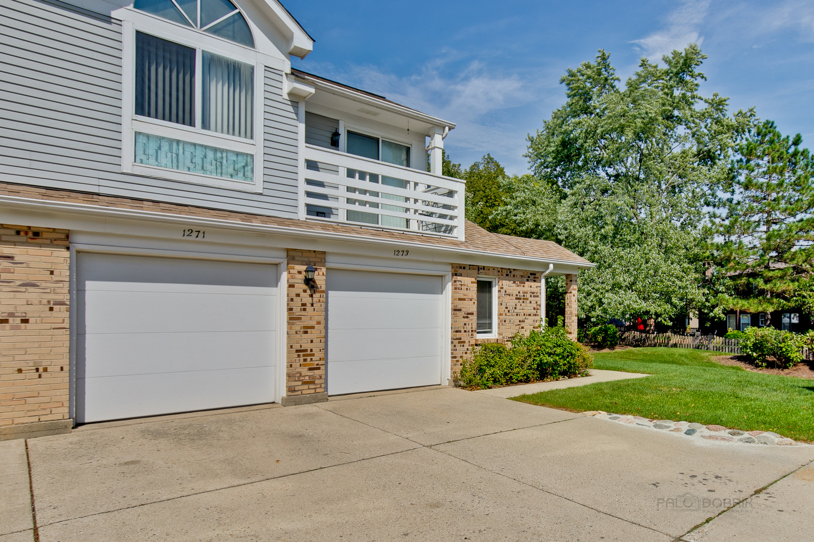 1271 Ranchview Court Buffalo Grove, IL 60089 - Photo 19 of 25 a front view of a house with yard and garage