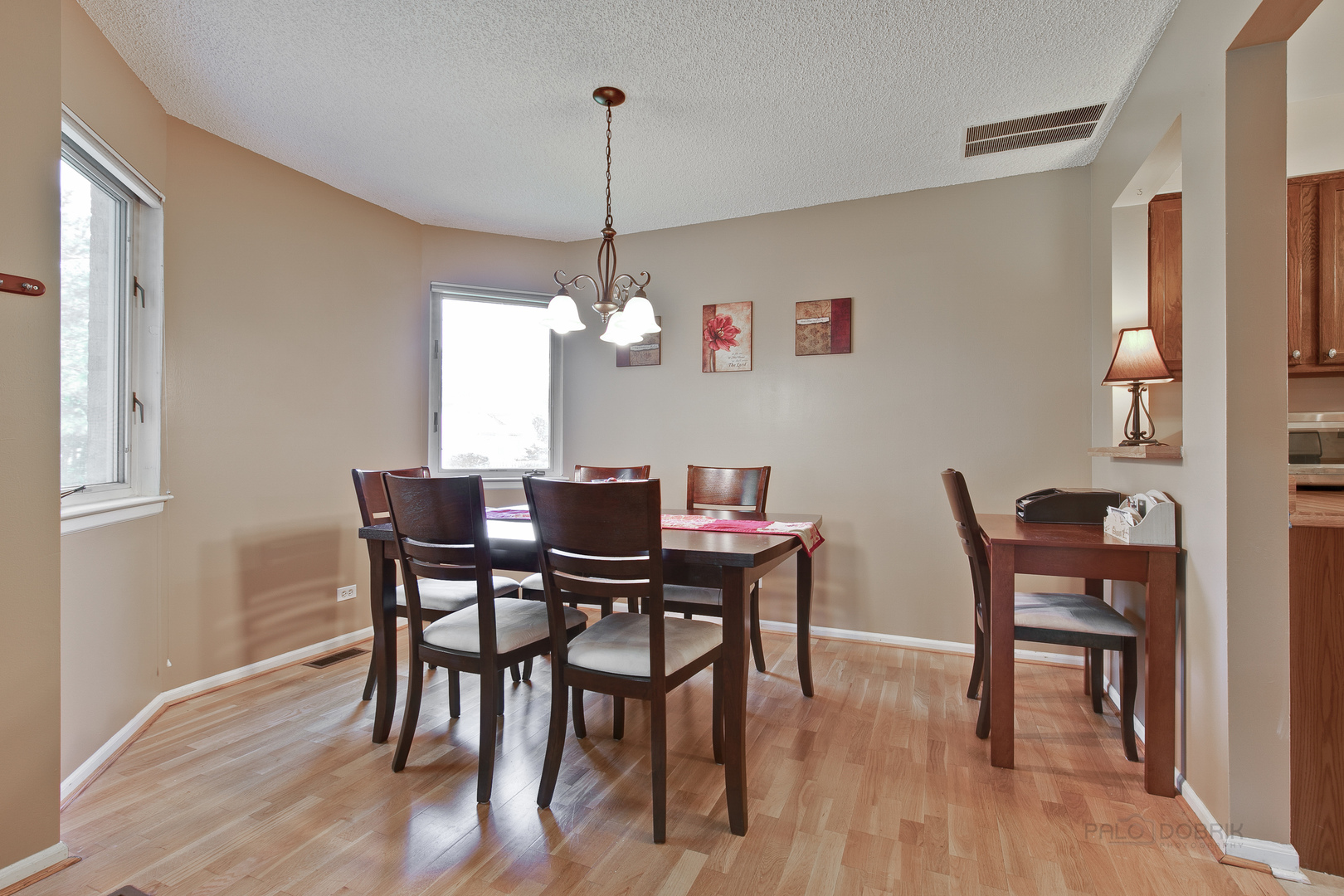 1271 Ranchview Court Buffalo Grove, IL 60089 - Photo 6 of 25 a view of a dining room with furniture window and wooden floor
