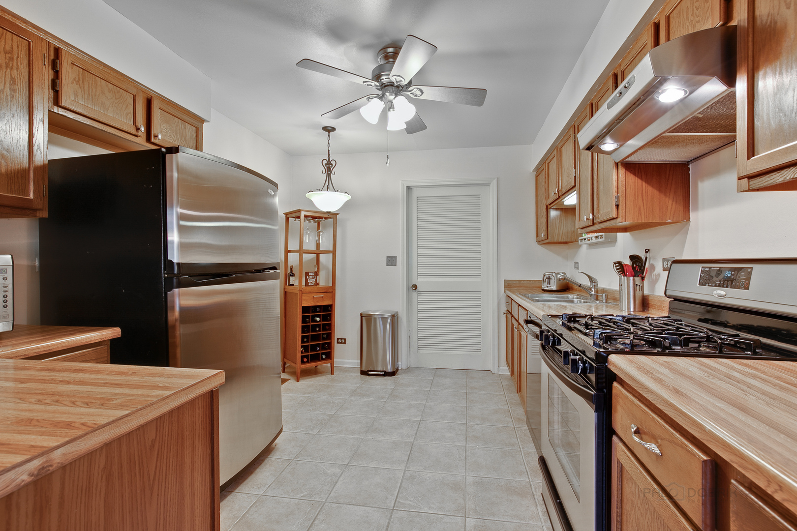 1271 Ranchview Court Buffalo Grove, IL 60089 - Photo 7 of 25 a kitchen with stainless steel appliances granite countertop a stove a refrigerator and a refrigerator