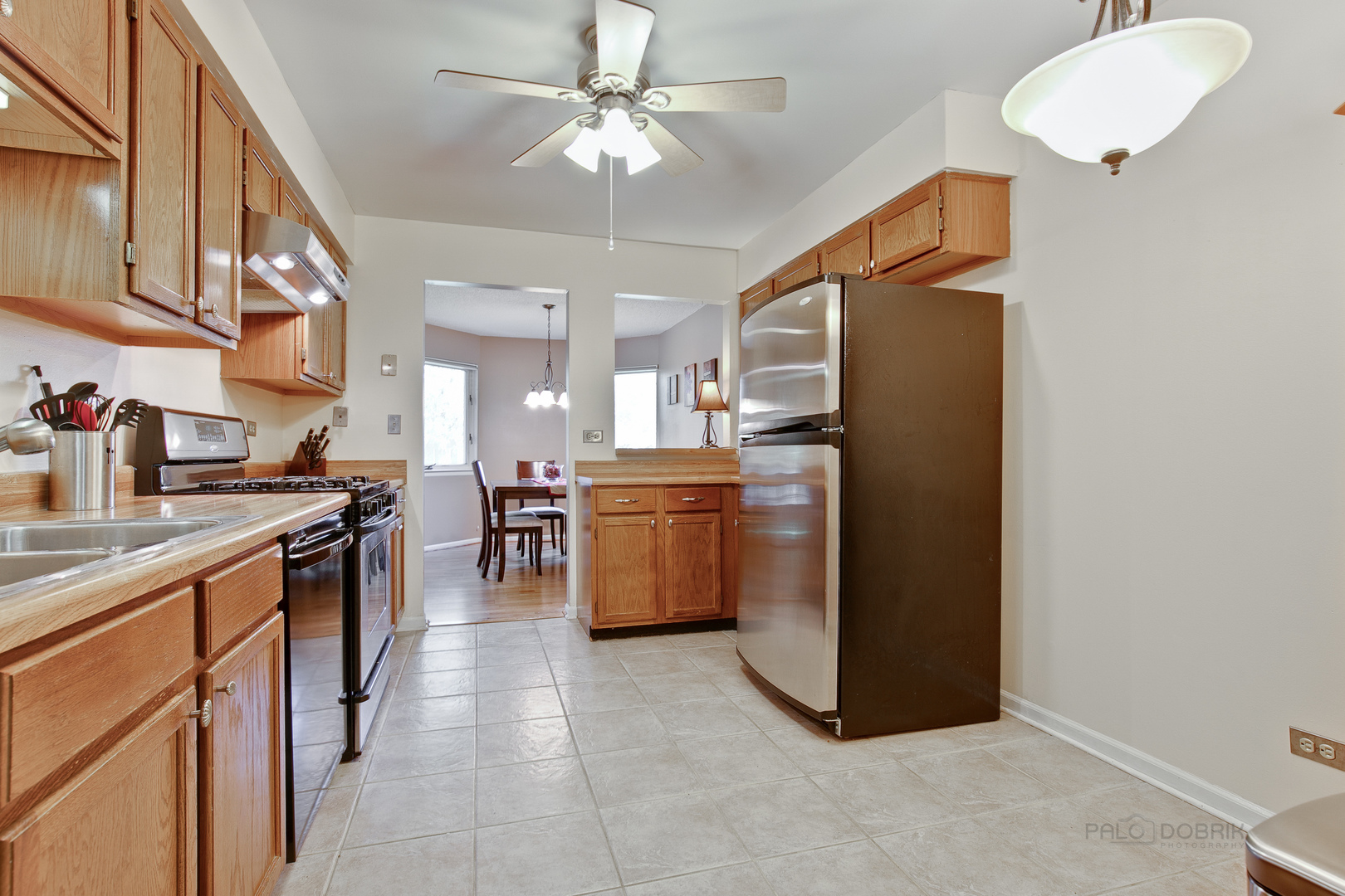 1271 Ranchview Court Buffalo Grove, IL 60089 - Photo 8 of 25 a kitchen with stainless steel appliances a stove a sink a refrigerator and island