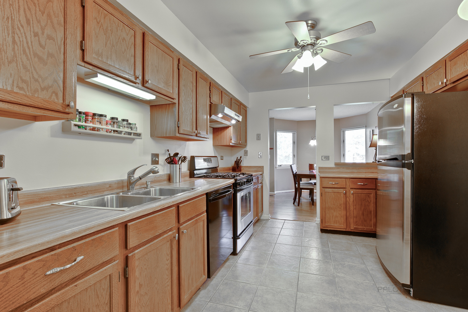 1271 Ranchview Court Buffalo Grove, IL 60089 - Photo 9 of 25 a kitchen with a sink stainless steel appliances and cabinets